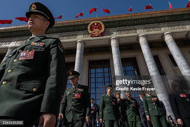 Members of the Chinese military leave after the second plenary session of the National People's Congress at the Great Hall of the People on March 9,...