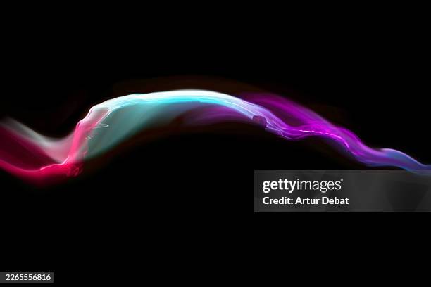 colorful dynamic neon light wave flowing on dark car silhouette in the studio - soufflerie photos et images de collection