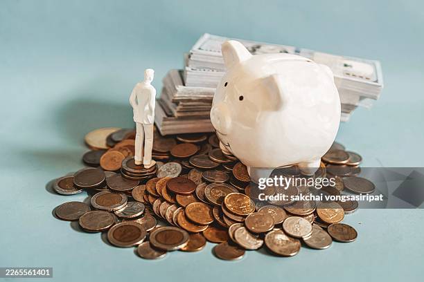 growing savings and interest rate concept with piggy bank on stacked coins - passive income stock pictures, royalty-free photos & images