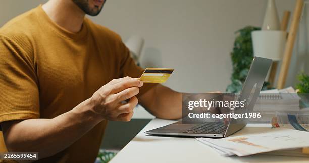 husband in electronic banking review. - materiale cartaceo foto e immagini stock