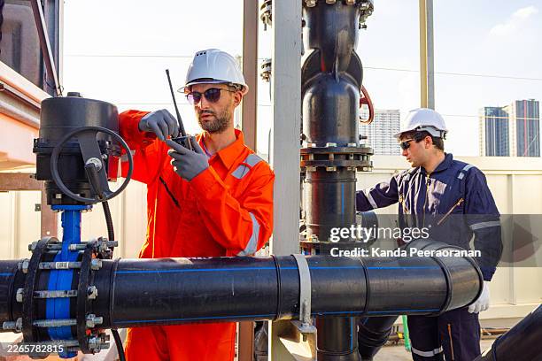 industrial engineers reviewing data at pipeline facility - temperature sensor stock pictures, royalty-free photos & images
