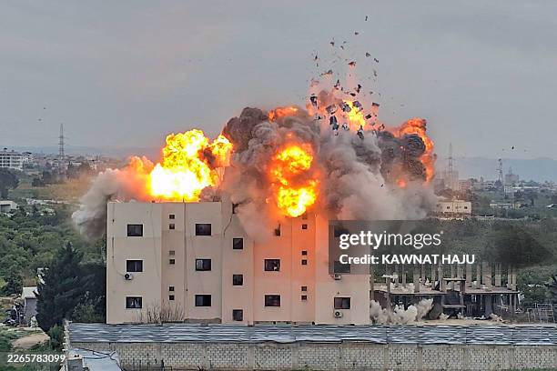 Fireball errupts from the site of an Israeli airstrike that targeted a building in the southern Lebanese village of Abbasiyyeh on March 13, 2026. UN...