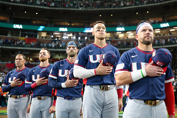 Members of Team USA line up along the base path for the national anthem prior to the 2026 World Baseball Classic Quarterfinals game presented by...