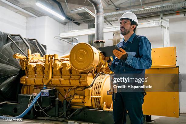 engineer supervising the operation of a power generator - generator stock pictures, royalty-free photos & images
