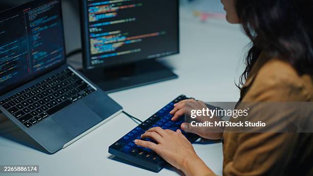 closeup latin software developer working late at computer in dark office at night. concentrating on writing code and solving complex technical problem, artificial intelligence and programming. - html stock pictures, royalty-free photos & images