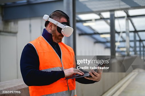 Construction worker using virtual reality headset and digital tablet Construction worker using virtual reality headset and digital tablet