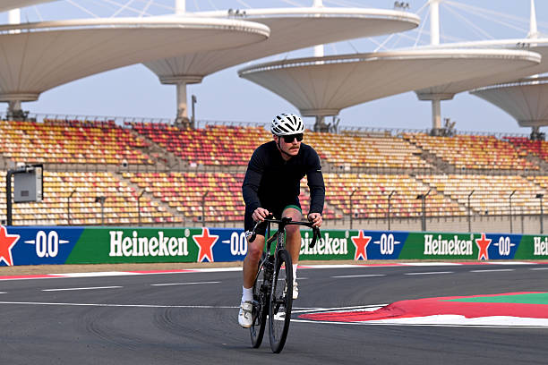 Valtteri Bottas of Finland and Cadillac F1 Team rides his bicycle on track during previews ahead of the F1 Grand Prix of China at Shanghai...
