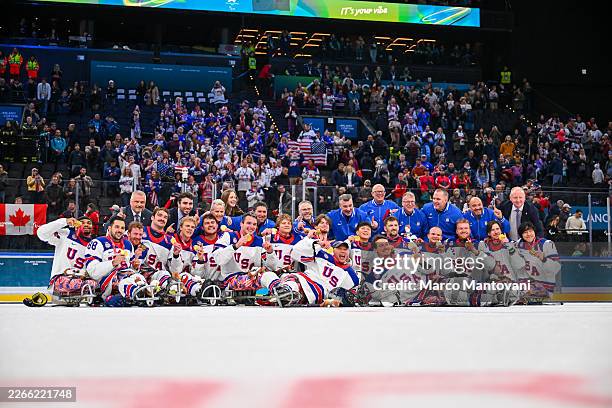 Gold medallists Team United States celebrate during the medal ceremony for the Para Ice Hockey Open Team Tournament on day nine of the Milano Cortina...