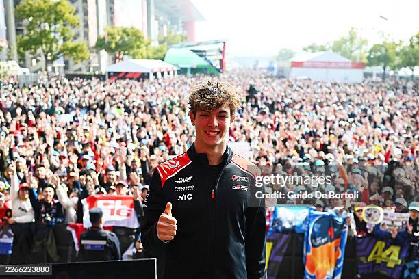 Oliver Bearman of Great Britain and Haas F1 poses for a photo with the fans in the fan zone prior to practice ahead of the F1 Grand Prix of China at...