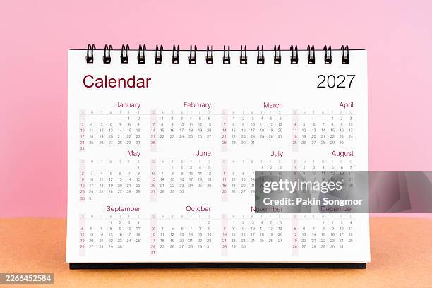 calendar 2027. desk yearly calendar stand on pink color background. - annual event stock pictures, royalty-free photos & images