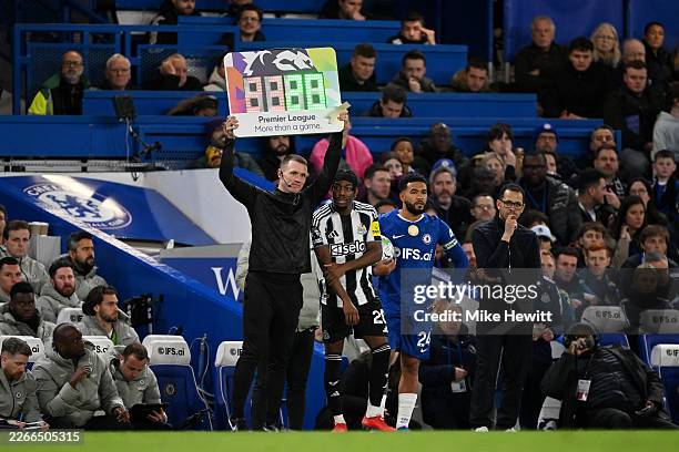 Fourth Official Tom Bramall holds up the Premier League "More than a game" substitution board during the Premier League match between Chelsea and...