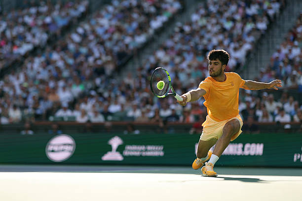 Carlos Alcaraz of Spain returns against Daniil Medvedev during their Men's Singles Semifinals match on Day 11 of the BNP Paribas Open at Indian Wells...