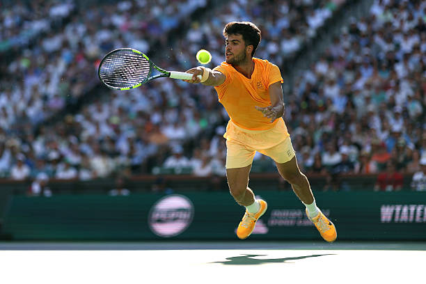 Carlos Alcaraz of Spain returns against Daniil Medvedev during their Men's Singles Semifinals match on Day 11 of the BNP Paribas Open at Indian Wells...