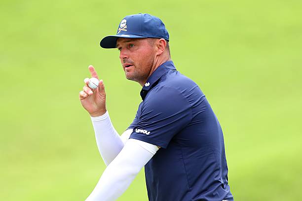 Bryson DeChambeau of Crushers GC acknowledges to the fan at 8th gree during day four of LIV Golf Singapore at Sentosa Golf Club on March 15, 2026 in...