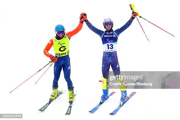 Sam Cozens of Team Great Britain celebrates with guide Adam Hall after competing in the Para Alpine Skiing Men's Slalom Vision Impaired on day nine...