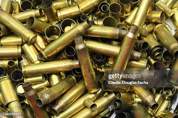 brass shell casings from gun bullets - ammunition stock pictures, royalty-free photos & images