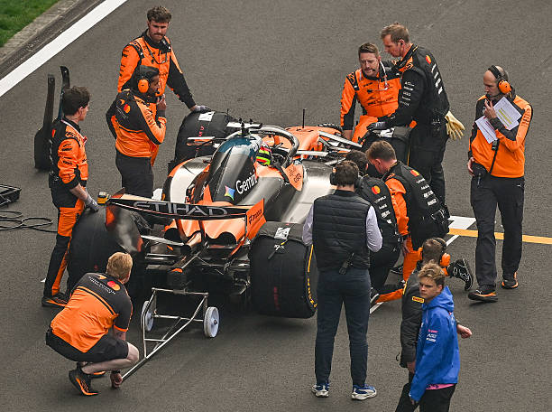McLaren Mastercard Formula One Team mechanics inspect and prepare Oscar Piastri's MCL40 on the starting grid minutes before the 2026 Chinese Grand...