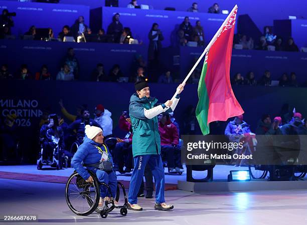 Raman Svirydzenka and Valiantsina Biryla flagbearers of Team Belarus carry the flag during the Milano Cortina 2026 Winter Paralympic Games closing...