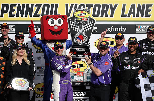 Denny Hamlin, driver of the Yahoo! Toyota, celebrates in victory lane after winning the NASCAR Cup Series Pennzoil 400 presented by Jiffy Lube at Las...