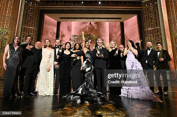 In this handout photo provided by The Academy, the cast and crew of Best Picture winner "One Battle After Another" pose during the 98th Oscars at...