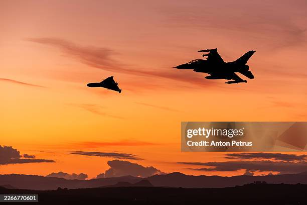 fighter jet and heavy kamikaze drone - military airplane stock pictures, royalty-free photos & images