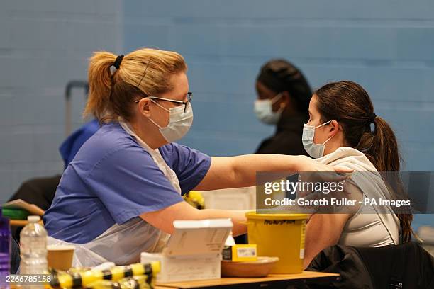 Student receiving an injection in the sports hall at the University of Kent campus in Canterbury as the number of cases of meningitis being...