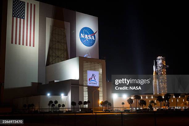 In this handout image provided by NASA, NASA's Space Launch System rocket and Orion spacecraft, secured to the mobile launcher, is seen as it rolls...