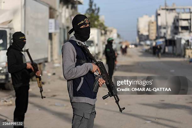 Members of Palestinian Hamas's Ezzedine Al-Qassam Brigades and Islamic Jihad's Quds Brigades are deployed at intersections for Eid al-Fitr prayers,...