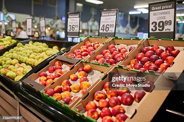 nectarines on display in supermarket produce section with price signs and cardboard crates - grocer stock pictures, royalty-free photos & images