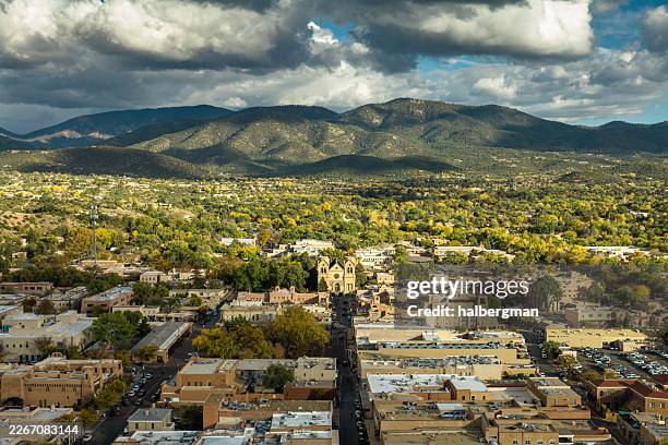 aerial view of downtown santa fe with cathedral basilica and background mountains - santa fe stockfoto's en -beelden