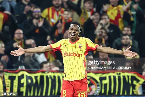 Lens' Malian midfielder Mamadou Sangare celebrates scoring his team's third goal during the French L1 football match between RC Lens and SCO Angers...