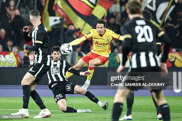 Lens' French forward Florian Thauvin kicks the ball next to Angers' French defender Florent Hanin during the French L1 football match between RC Lens...