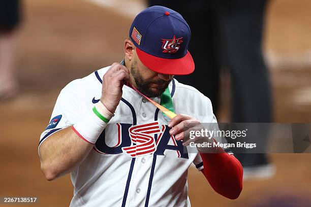 Kyle Schwarber of Team United States reacts after receiving a silver medal following the 3-2 defeat against Team Venezuela at loanDepot park on March...