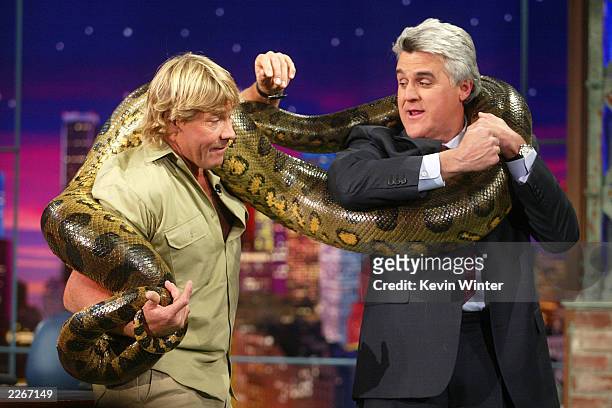 S "Crocodile Hunter" Steve Irwin wraps an anaconda snake around host Jay Leno on "The Tonight Show with Jay Leno" at the NBC studios February 4, 2003...