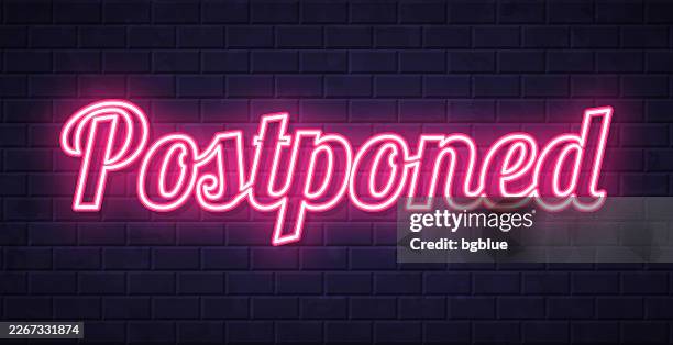 postponed - glowing neon text on brick wall background - wall shelf stock illustrations