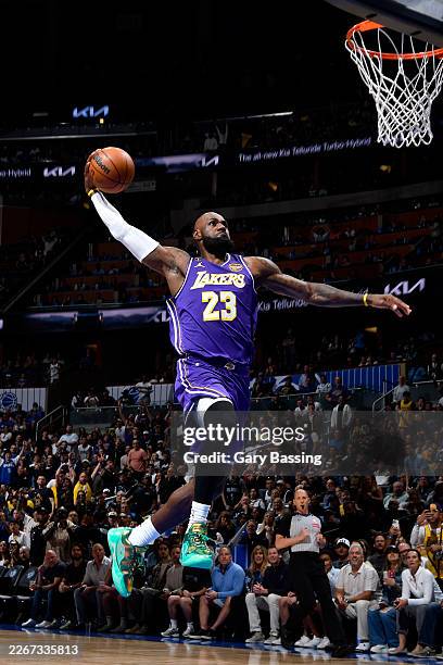 LeBron James of the Los Angeles Lakers dunks the ball during the game against the Orlando Magic on March 21, 2026 at Kia Center in Orlando, Florida....