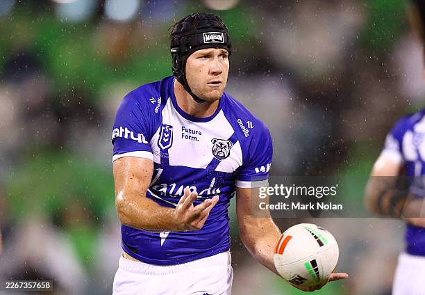 Nolan Stringer Matt Burton of the Bulldogs passes during the round three NRL match ...