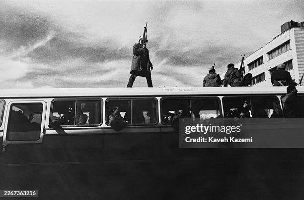Armed men atop a bus during the Iranian Revolution, Tehran, Iran, 1979.