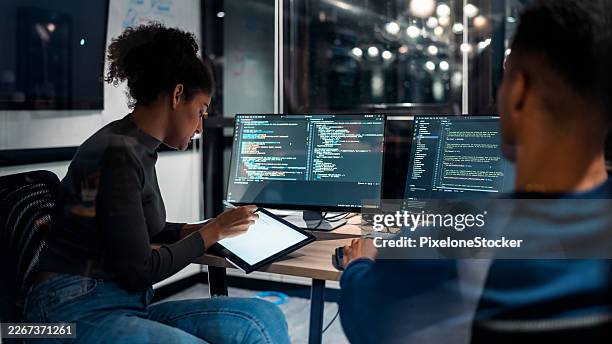 software developers in modern office collaborating analysing the coding on computer screen. - software development stock pictures, royalty-free photos & images