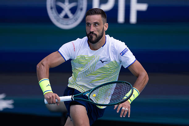 Damir Dzumhur of Bosnia-Herzegovina competes against Jannik Sinner of Italy during their match on Day 5 of the Miami Open at Hard Rock Stadium in...
