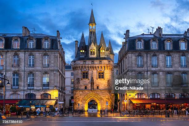 porte cailhau in bordeaux at dusk with cafés - aquitaine stock pictures, royalty-free photos & images