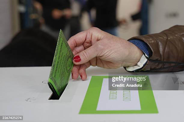 Voter casts her ballot at a polling station in Rome, Italy, on March 22, 2026. Around 46 million Italians are heading to the polls on March 22 and 23...