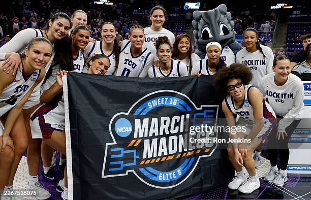 The TCU Horned Frogs pose for a photo following the team's overtime victory over the Washington Huskies in the Second Round of the NCAA Women's...