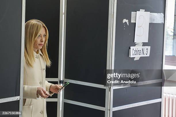 Italian Premier Giorgia Meloni leaves the booth after voting in a constitutional referendum on a reform of the Italian judicial system at a polling...
