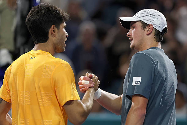 Carlos Alcaraz of Spain is congratulated by Joao Fonseca of Brazil after their match on Day 4 of the Miami Open Presented by Itau at Hard Rock...