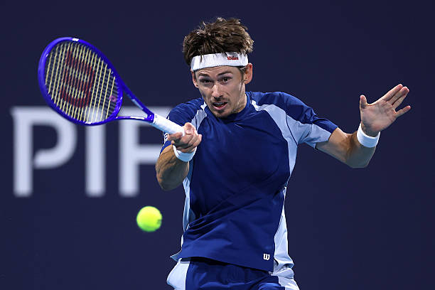 Alex de Minaur of Australia returns a shot to Stefanos Tsitsipas of Greece on Day 4 of the Miami Open Presented by Itau at Hard Rock Stadium on March...