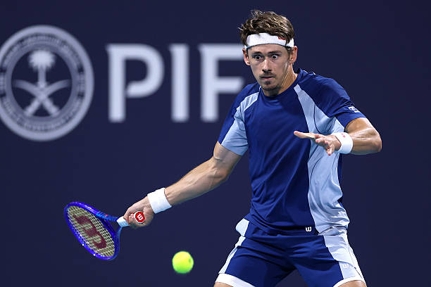 Alex de Minaur of Australia returns a shot to Stefanos Tsitsipas of Greece on Day 4 of the Miami Open Presented by Itau at Hard Rock Stadium on March...