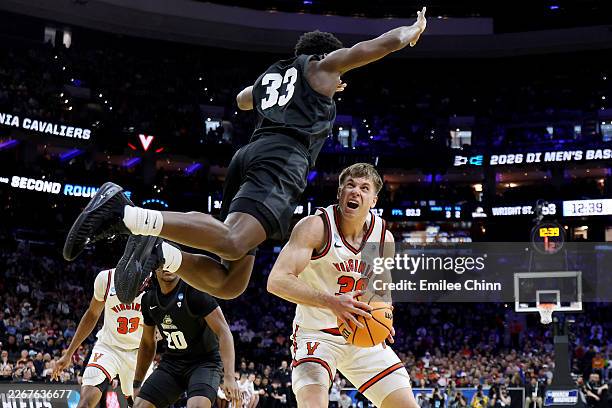 Dallin Hall of the Virginia Cavaliers attempts a shot while being fouled by Michael Imariagbe of the Wright State Raiders during the second half in...