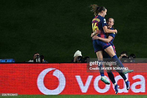 Barcelona's Polish forward Ewa Pajor celebrates with Barcelona's Spanish midfielder Clara Serrajordi after scoring her team's fourth goal during the...