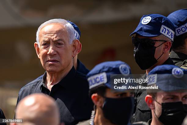 Israeli Prime Minister Benjamin Netanyahu reacts while visiting the area destroyed by an Iranian ballistic missile last night, leaving over 50...
